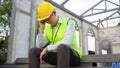 Asian Engineering man with safety helmet feeling sad in construction site