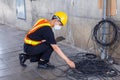 Asian engineers wearing hard hat and safety vest use tablet to test the electrical system. Royalty Free Stock Photo