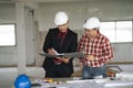 Asian engineers were consulted together and plan in construction site, engineering concept Royalty Free Stock Photo
