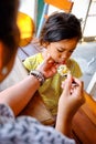 Asian Boy Showing Cranky Facial Expression while Being Feed Lunch Meals by His Mother in A Restaurant