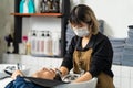 Asian expert Hairdresser massage and washing hair of beautiful young male customer on salon washing bed. Hairstylist wearing face Royalty Free Stock Photo