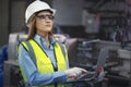 Asian factory worker woman hold laptop