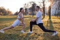 Asian famale and caucasian male couple Exercise in the outdoor park in the morning. They are healthy, smiling and happy. Royalty Free Stock Photo