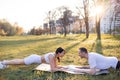 Asian famale and caucasian male couple Exercise in the outdoor park in the morning. They are healthy, smiling and happy Royalty Free Stock Photo
