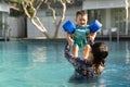 Beautiful mother and cute baby boy happinese in swimming pool