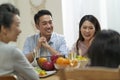 Asian family chatting while eating meal Royalty Free Stock Photo