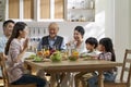 Asian family chatting while eating meal Royalty Free Stock Photo