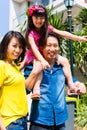 Asian family with child standing in front of home Royalty Free Stock Photo