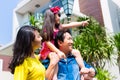 Asian family with child standing in front of home Royalty Free Stock Photo