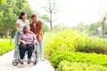 grandson and granddaughter Take grandma in a wheelchair for a walk in the park. Royalty Free Stock Photo