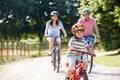 Asian Family On Cycle Ride In Countryside Royalty Free Stock Photo