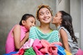 Asian Family Domestic Lifestyle. Children Showing Happiness and Love To Their Stay at Home Mother While Doing Their Laundry