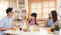 Asian family enjoy eating breakfast together in kitchen room at home Royalty Free Stock Photo