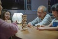 Asian family enjoy playing toy block with little daughter together in home