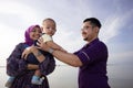 Asian family enjoying quality time on the beach Royalty Free Stock Photo