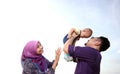 Asian family enjoying quality time on the beach Royalty Free Stock Photo