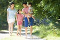 Asian Family Enjoying Walk In Countryside Royalty Free Stock Photo
