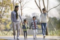 Asian family enjoying a walk outdoors in city park Royalty Free Stock Photo