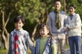 Asian family enjoying a walk outdoors in city park Royalty Free Stock Photo