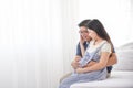 Asian family, father embrace his wife eight months pregnant and talking with love Royalty Free Stock Photo