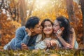 Asian family, father, mother and daugther having goodtime together in park in autumn season