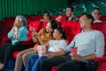 Asian family father, mother, son and grandmother watching movie at the cinema happily on weekends Royalty Free Stock Photo