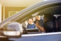 Asian family of father, mother and son waving goodbye to grandfather and grandmother as they take off their journey. Royalty Free Stock Photo