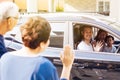 Asian family of father, mother and son waving goodbye to grandfather and grandmother as they take off their journey. Royalty Free Stock Photo