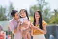 Asian family father mother and young daughter playing together at amusement park. concept family outing at the playground vacation Royalty Free Stock Photo