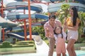 Asian family father mother and young daughter playing together at amusement park. concept family outing at the playground vacation Royalty Free Stock Photo