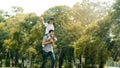 Asian family Father and son sat on his shoulders and run in the park.