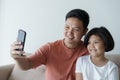 This Asian family has a father and daughter . A little girl And father video call they are happy in their home ather