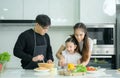 Asian family They are having cooking together happily in the kitchen room Royalty Free Stock Photo