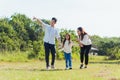 Asian family having fun and enjoying outdoor walking down the road outside together in the park