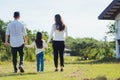 Asian family having fun and enjoying outdoor walking down the road outside together in the park Royalty Free Stock Photo