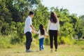 Asian family having fun and enjoying outdoor walking down the road outside together in the park Royalty Free Stock Photo