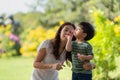 Asian family having fun mother and her son playing with soap bubbles in the park together Royalty Free Stock Photo