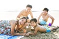 Asian family having good time at the beach