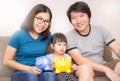 Asian family holding piggy bank in the living room Royalty Free Stock Photo