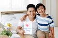 Asian family I love you, dad! Handsome man at home with his little boy. Happy Father`s Day. Concept Greeting card