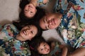 Asian family laying on floor smiling