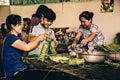 Asian family in the Mekong Delta preparing food by wrapping it in leaves. (Ho Chi Minh City, Vietnam - 2/01/2020