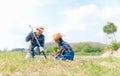 Asian family mom and child girl plant sapling tree