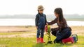 Asian family mom and kid daughter plant sapling tree outdoors Royalty Free Stock Photo