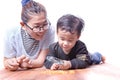 Asian family mother and children playing on wood floor Royalty Free Stock Photo