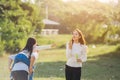 Asian family mother, father and little girl having fun together play blowing soap bubbles in park Royalty Free Stock Photo