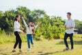 Asian family mother, father and little girl having fun together play blowing soap bubbles in park Royalty Free Stock Photo