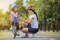 The asian family mother teaching children bicycle at the park Royalty Free Stock Photo