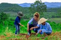 Asian family planting tree together