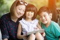 Asian family are playing together with a computer tablet in the Royalty Free Stock Photo